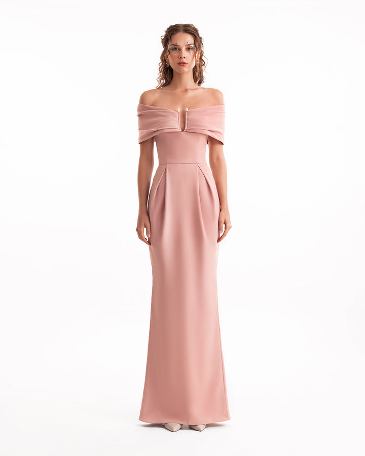 Woman wearing a pink off-shoulder gown on a white background