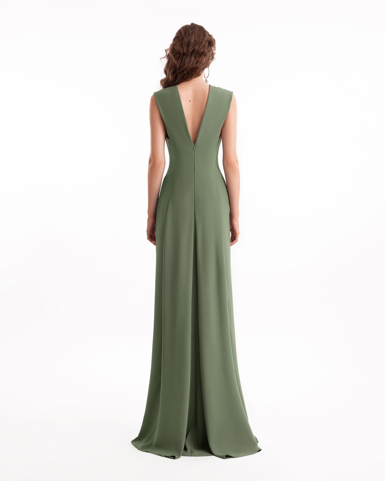 Green evening gown with a plunging neckline on a white background