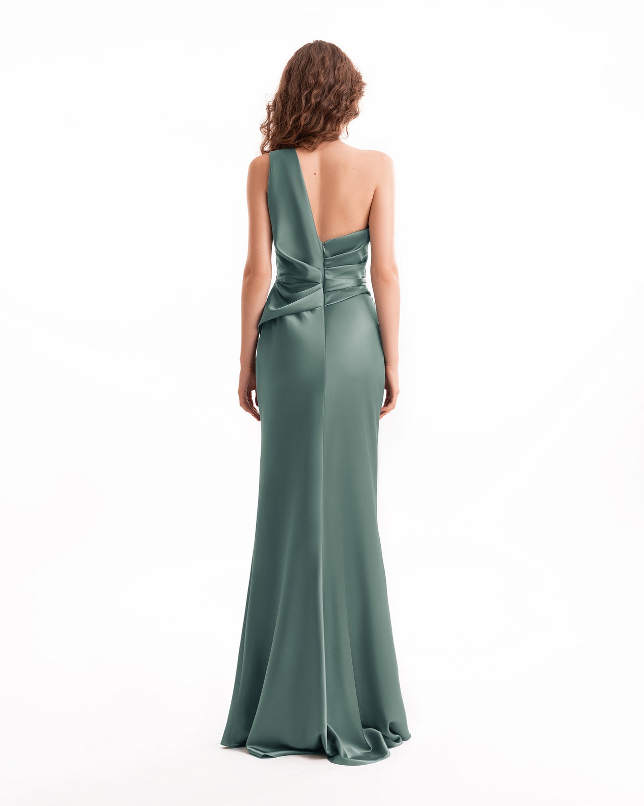 Woman wearing a green one-shoulder evening gown on a white background