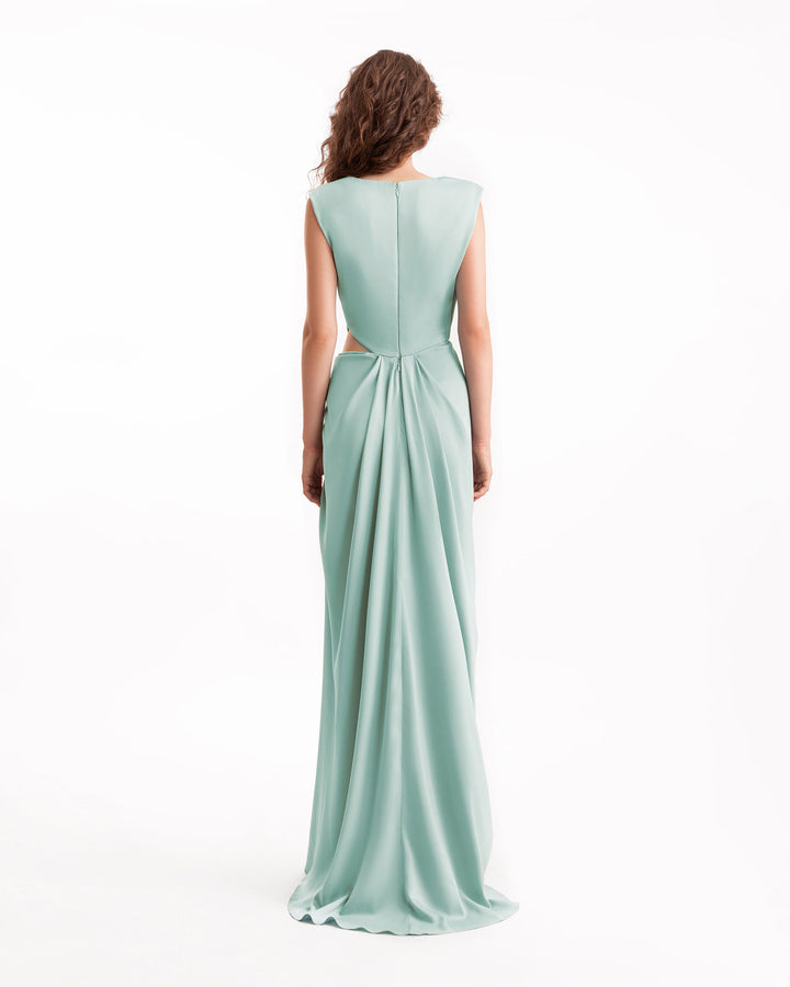 Woman wearing a light blue evening gown on a white background