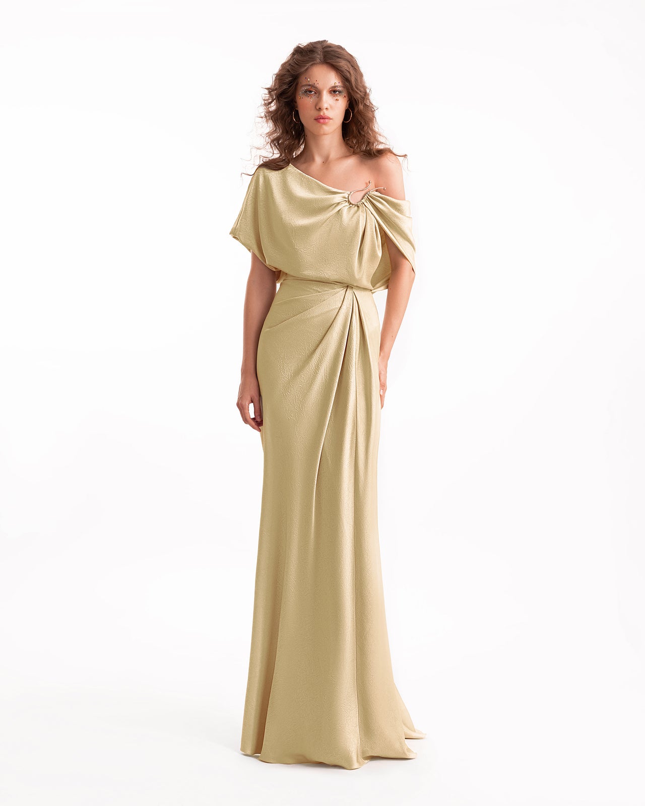 Woman wearing a gold evening gown on a white background