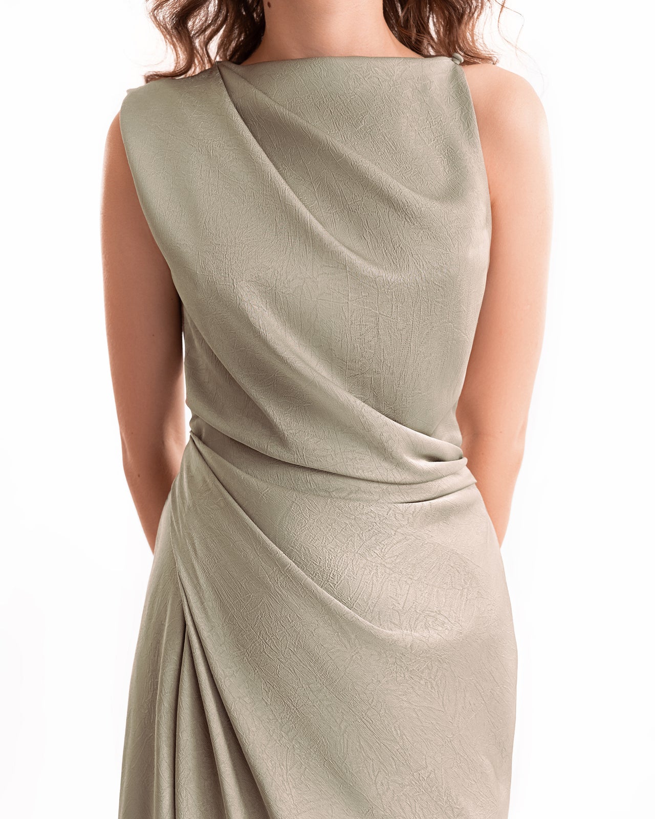 Light green dress with draped design on a white background
