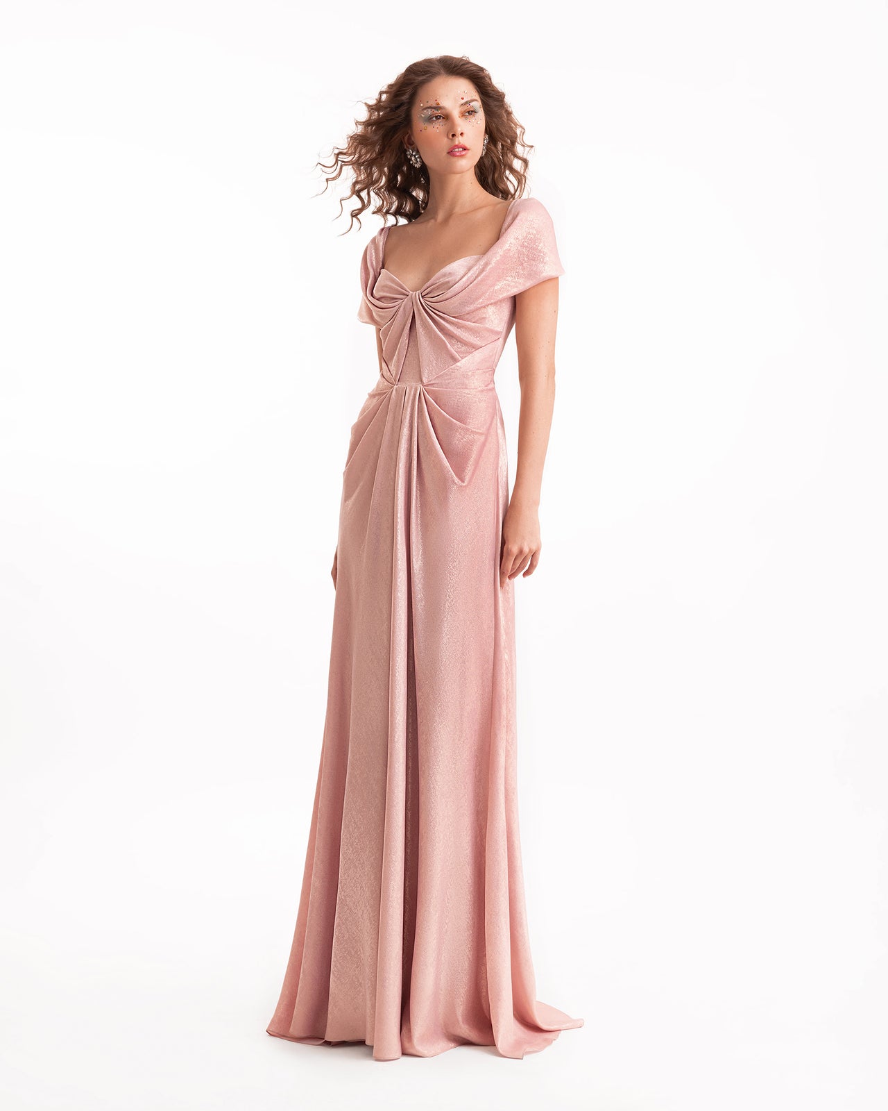 Woman wearing a pink evening gown on a white background