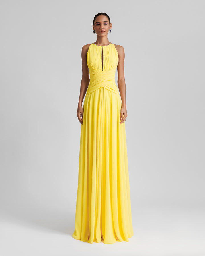 A long yellow dress featuring draping on the waist, beaded neckline and an open back.