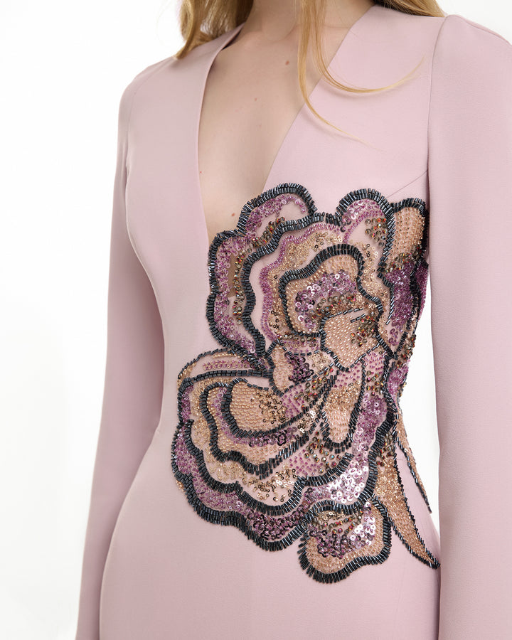 Pink dress with a floral sequin embellishment on a white background