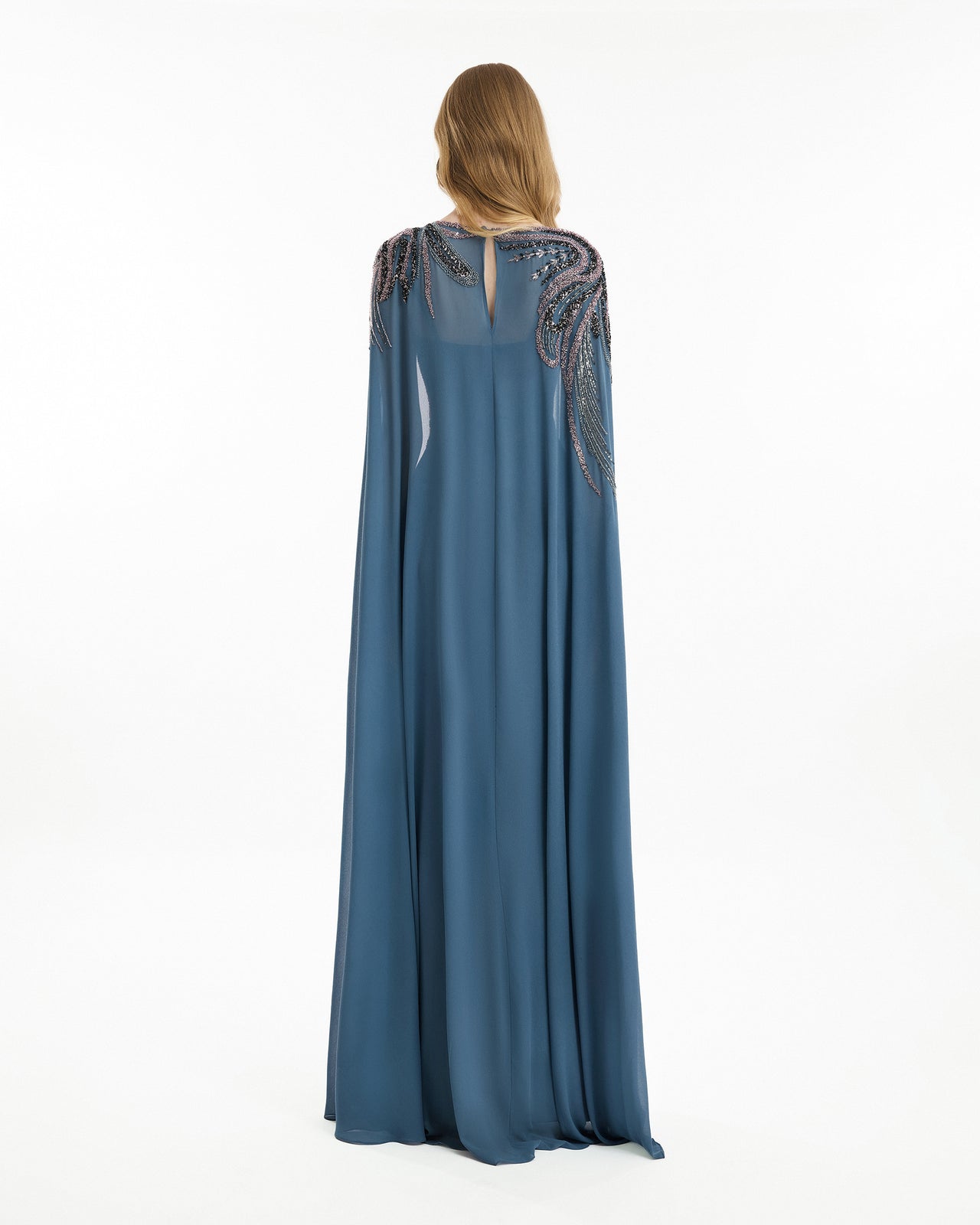 Long blue dress with intricate detailing on a white background