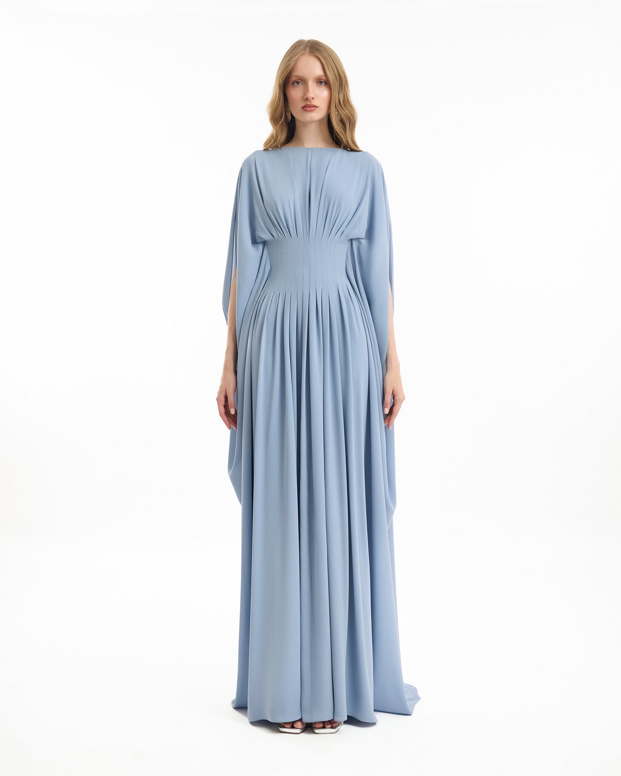 Woman wearing a light blue gown on a white background