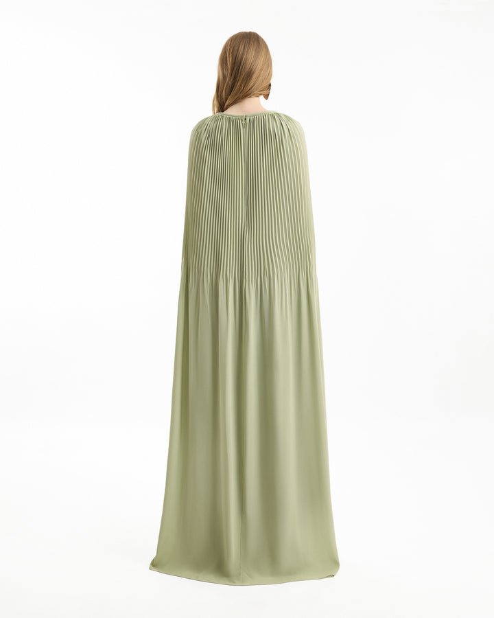 Person wearing a long green cape on a white background