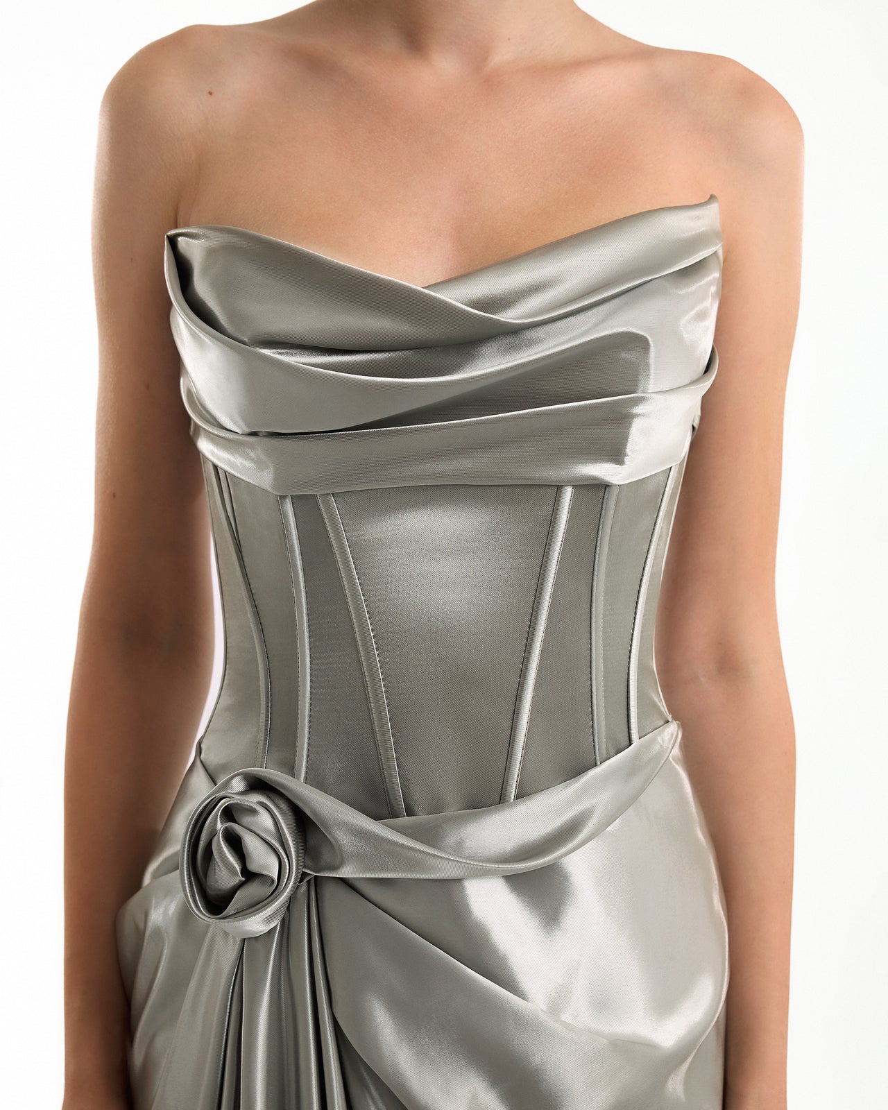 Silver strapless dress with a floral detail on a white background