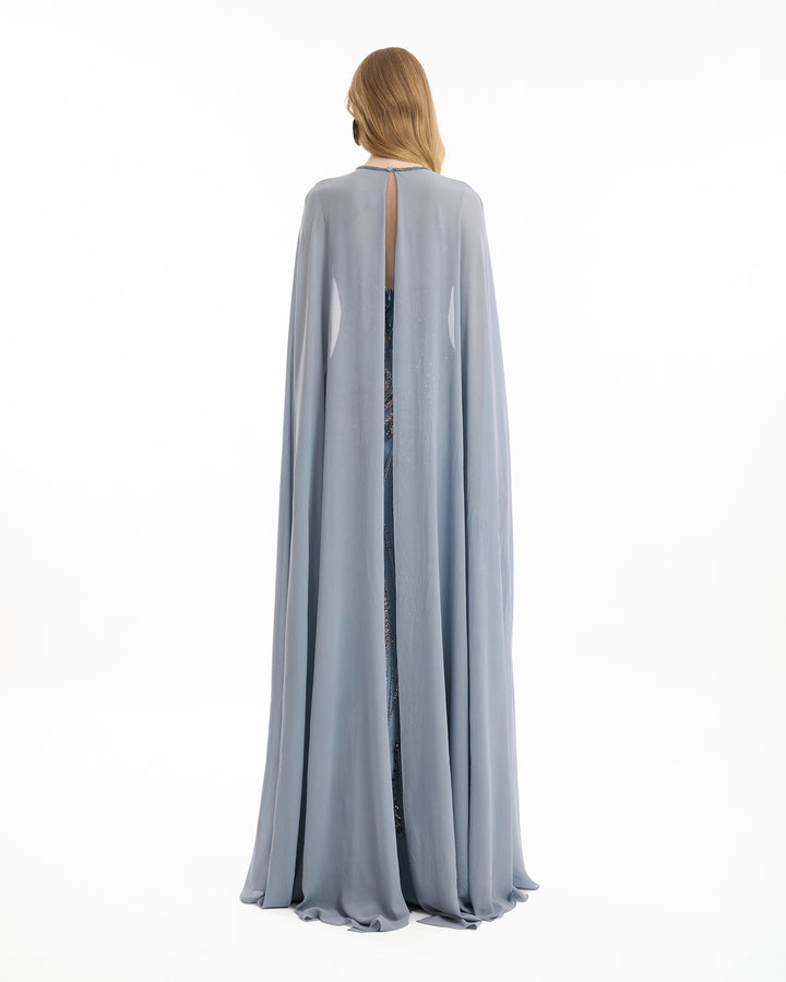 Long light gray cape worn by a person on a white background