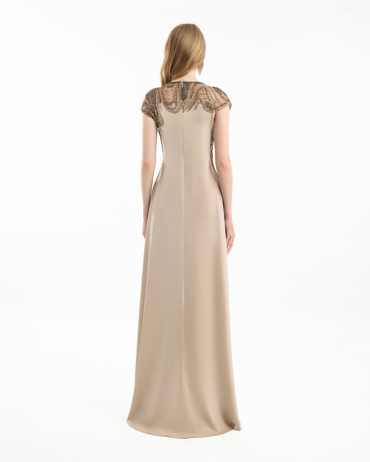 Beige evening gown with lace cap sleeves on a white background