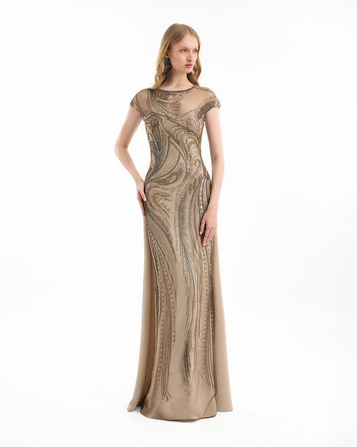 Woman wearing a long, patterned dress on a white background