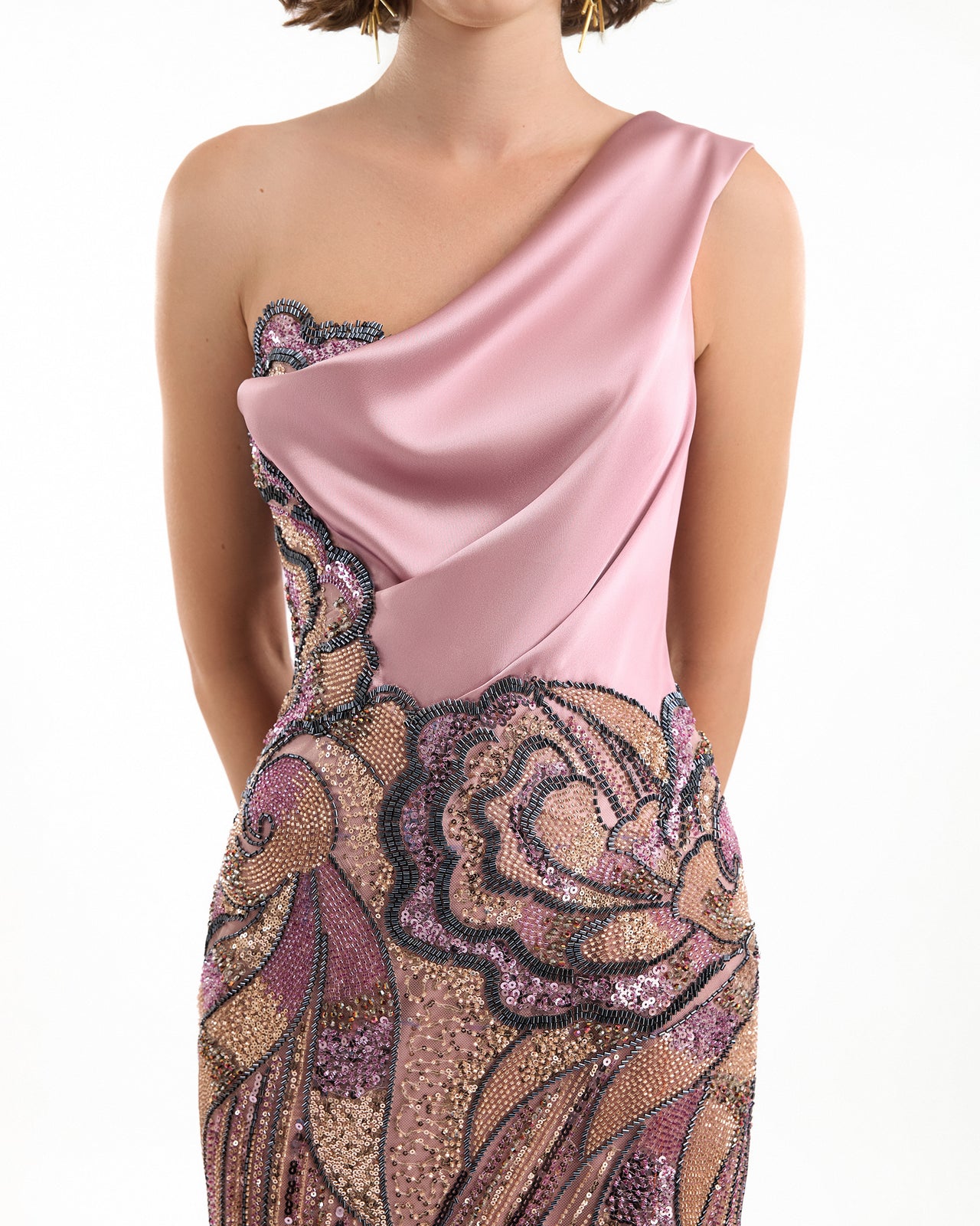 Pink evening gown with floral embellishments on a white background