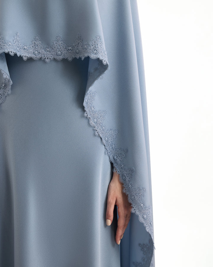 Blue dress with lace detailing on a white background