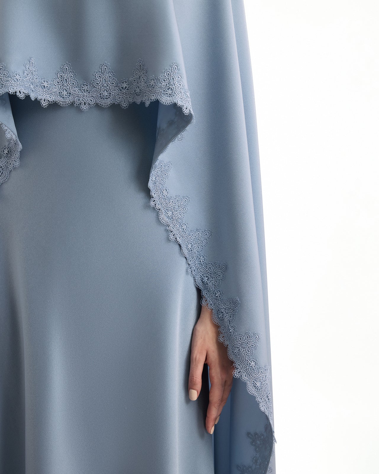 Blue dress with lace detailing on a white background