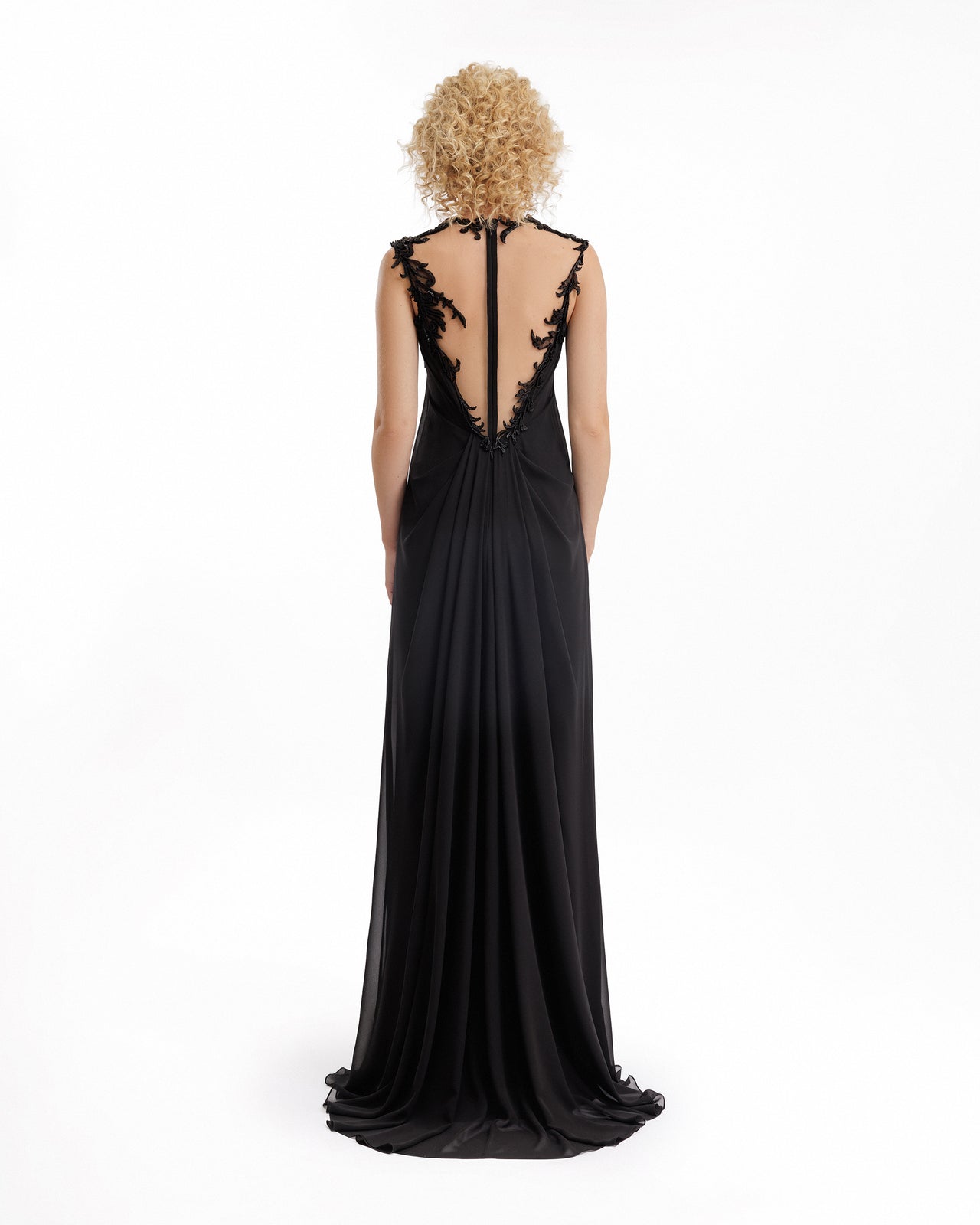 Black evening gown with lace detailing on a white background