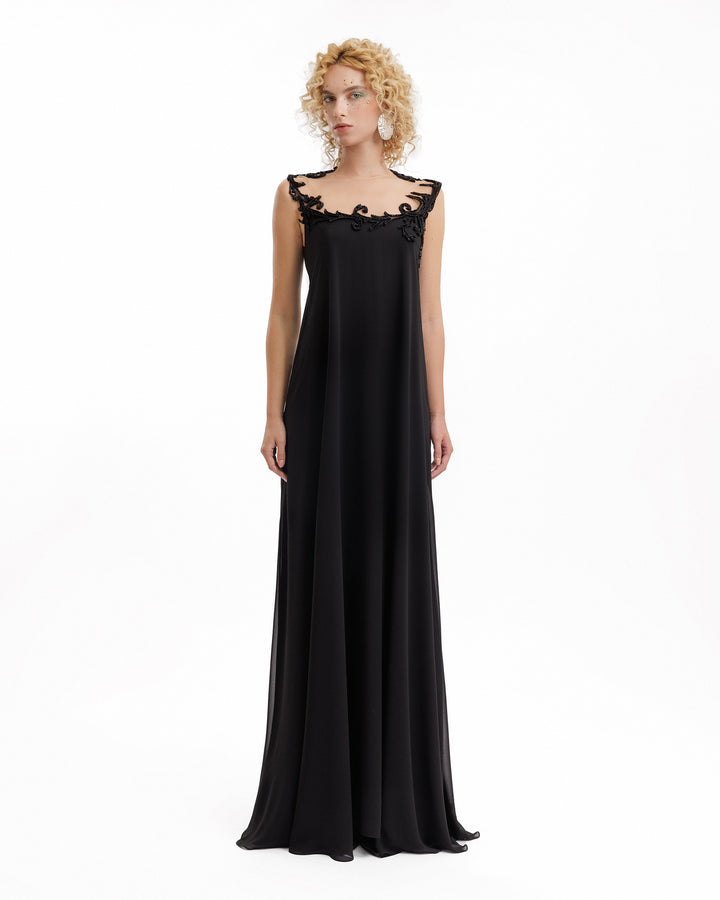 Black evening gown with lace detailing on a white background