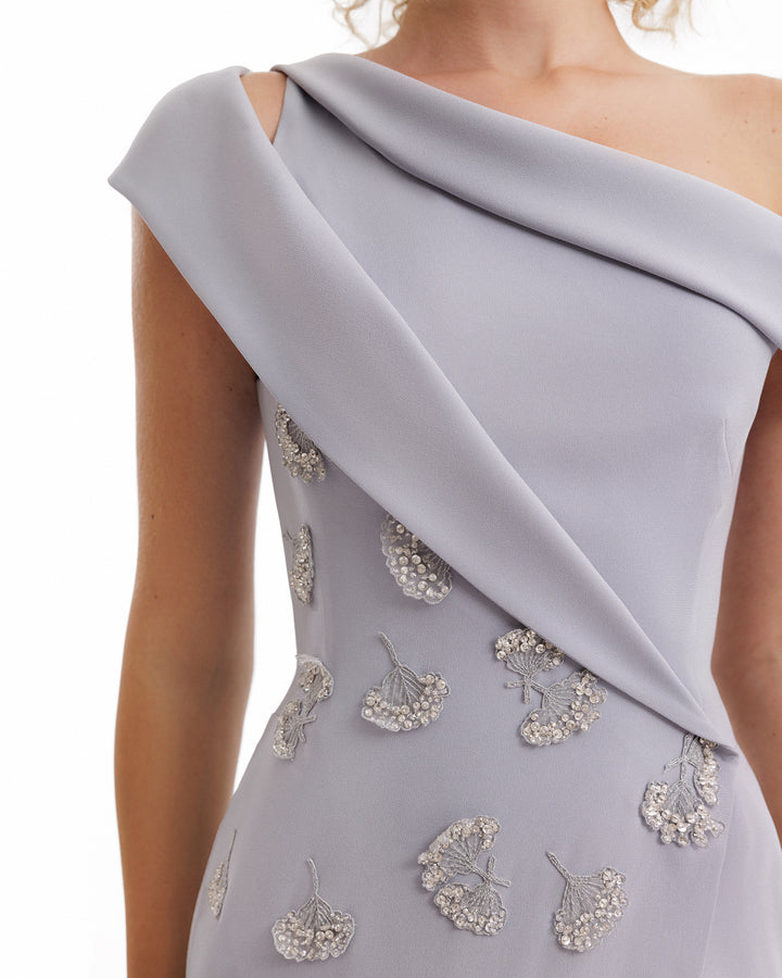 Gray evening gown with embellishments on a white background