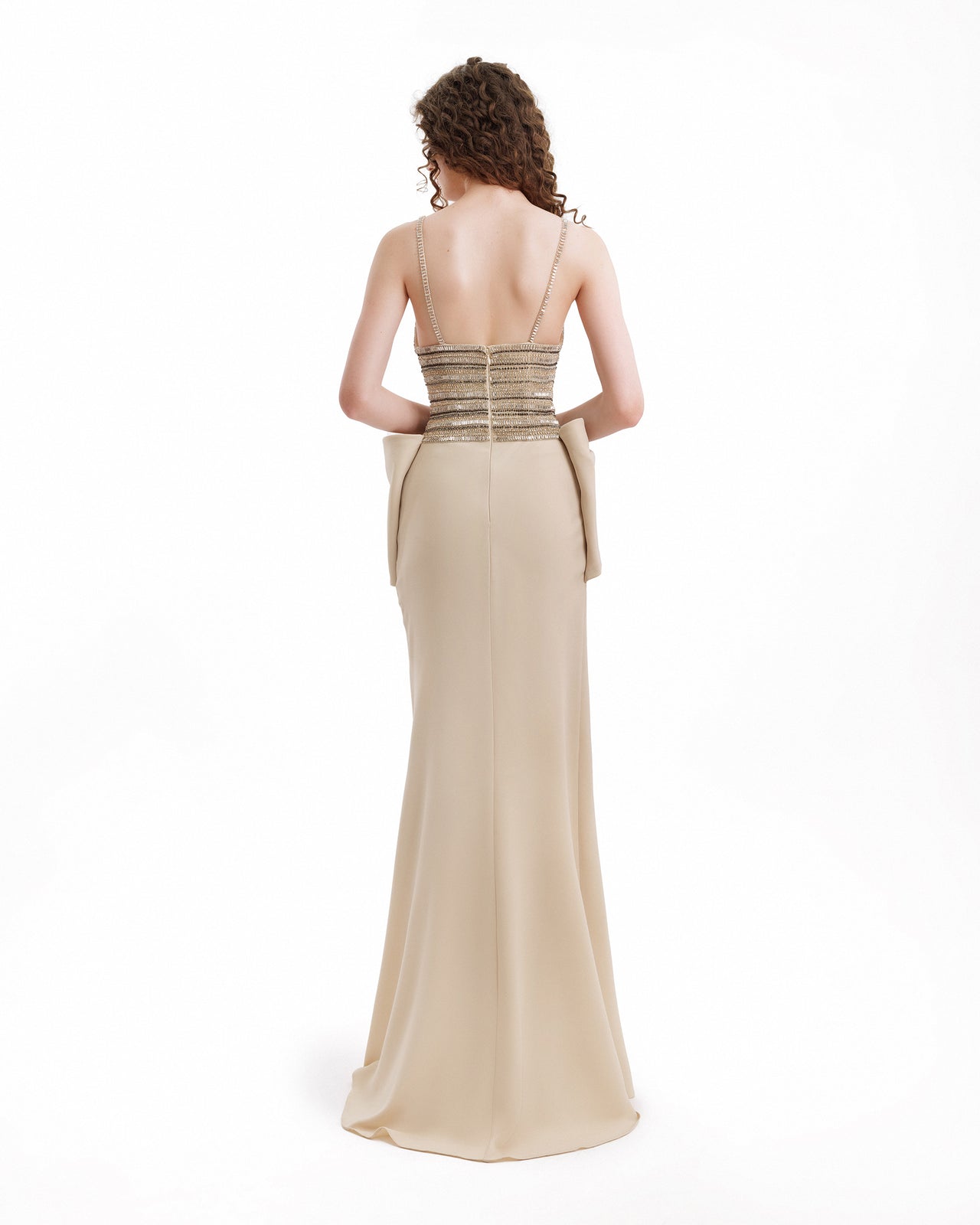 Beige evening gown with a fitted bodice and flowing skirt on a white background