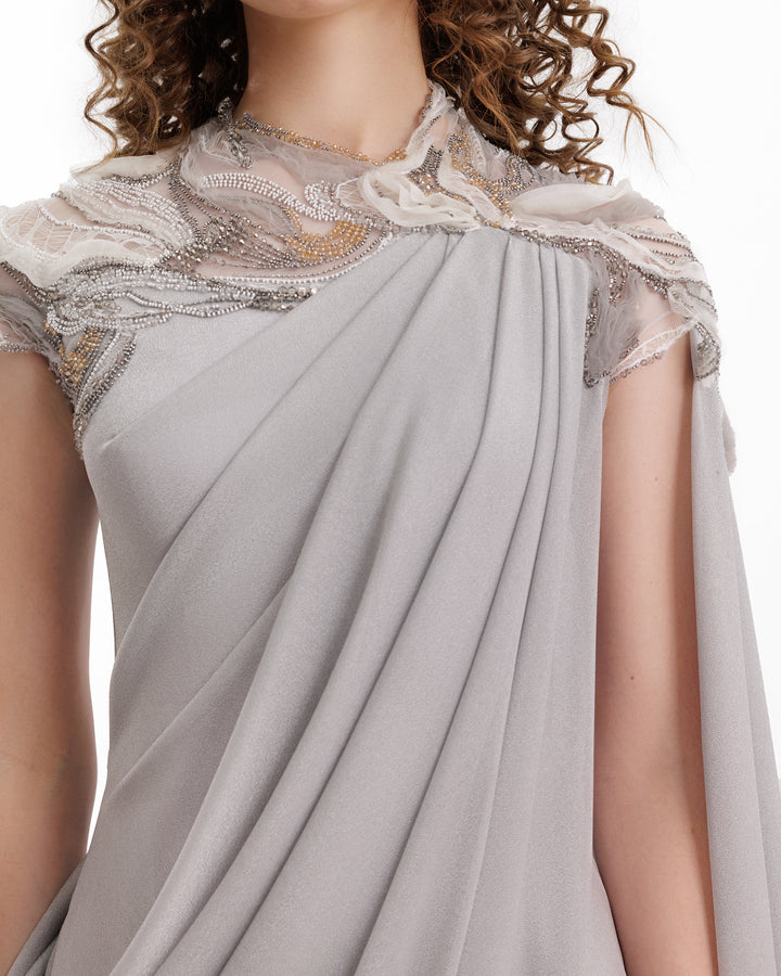 Gray saree with intricate lace detailing on a white background