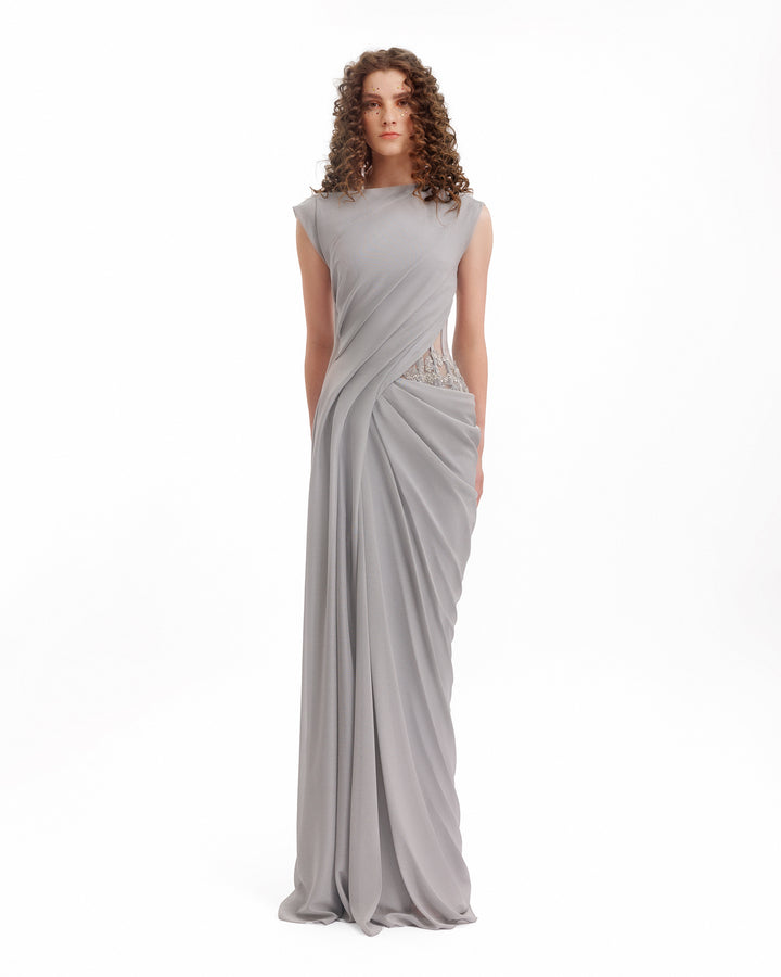 Woman wearing a gray evening gown on a white background