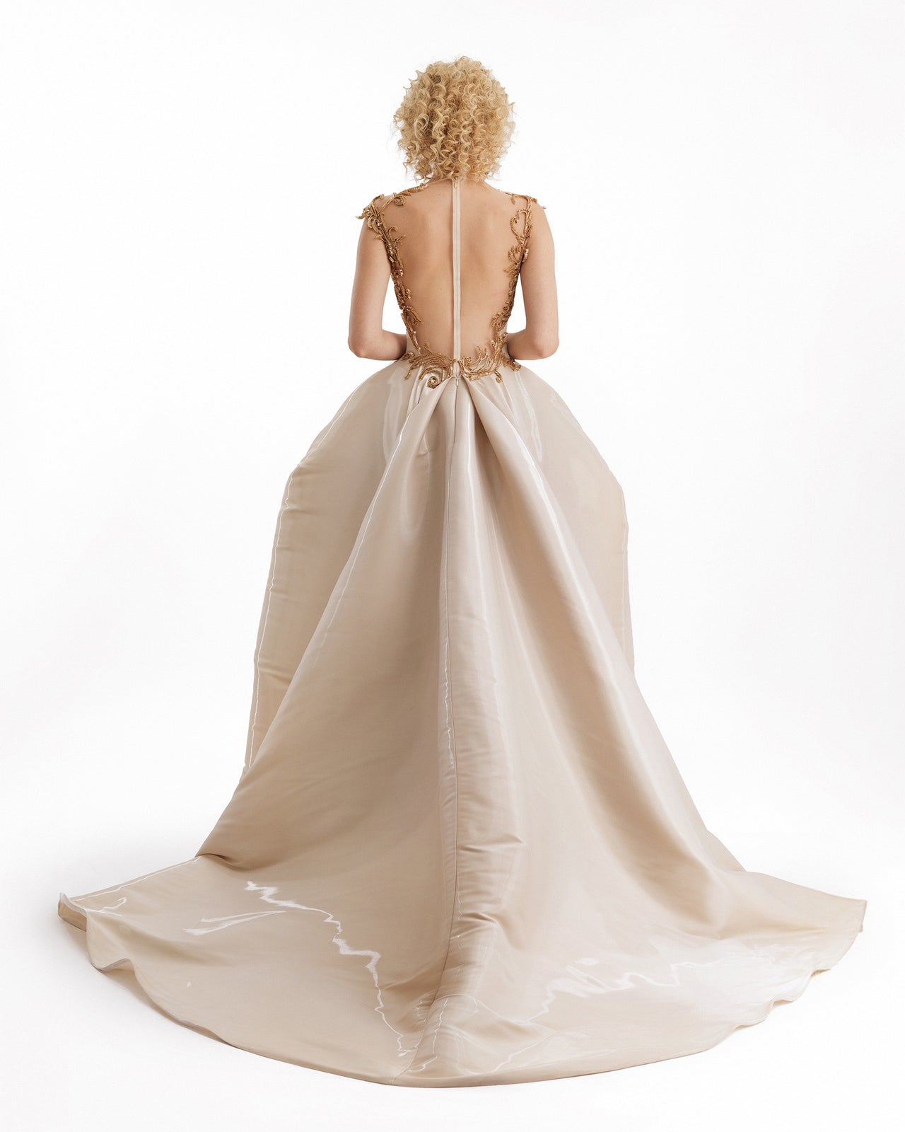 Beige evening gown with a long train on a white background