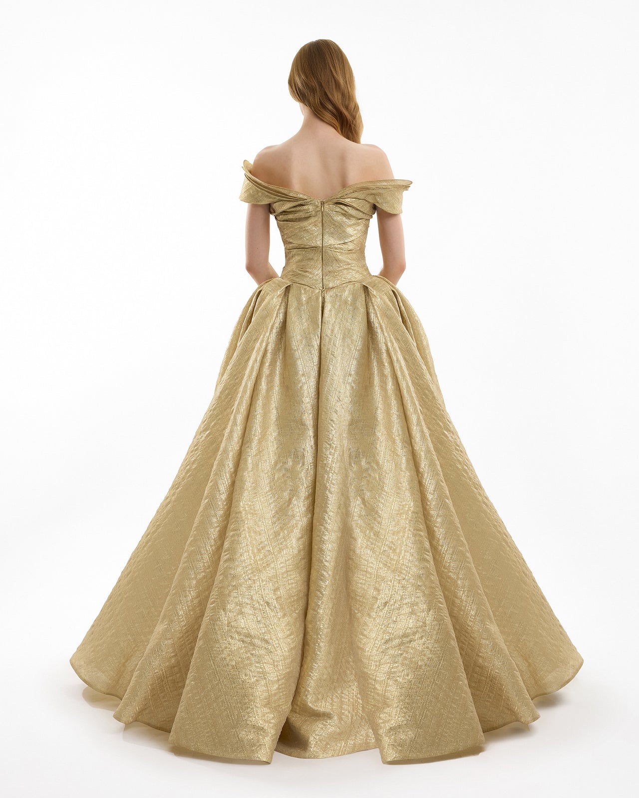 Gold off-shoulder gown on a white background
