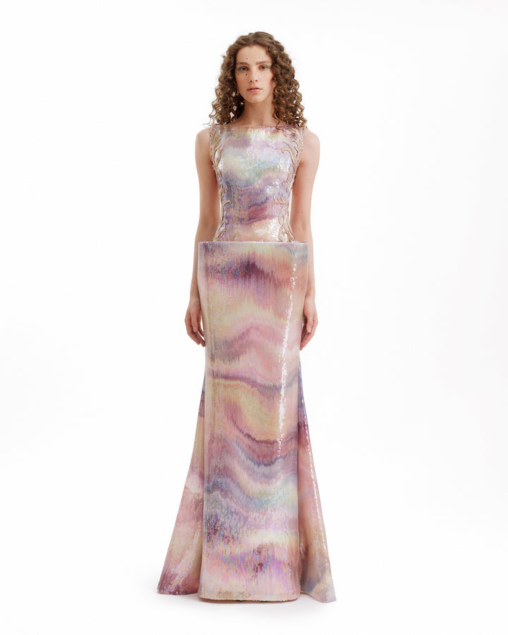 Woman wearing a sleeveless, long, multicolored dress on a white background