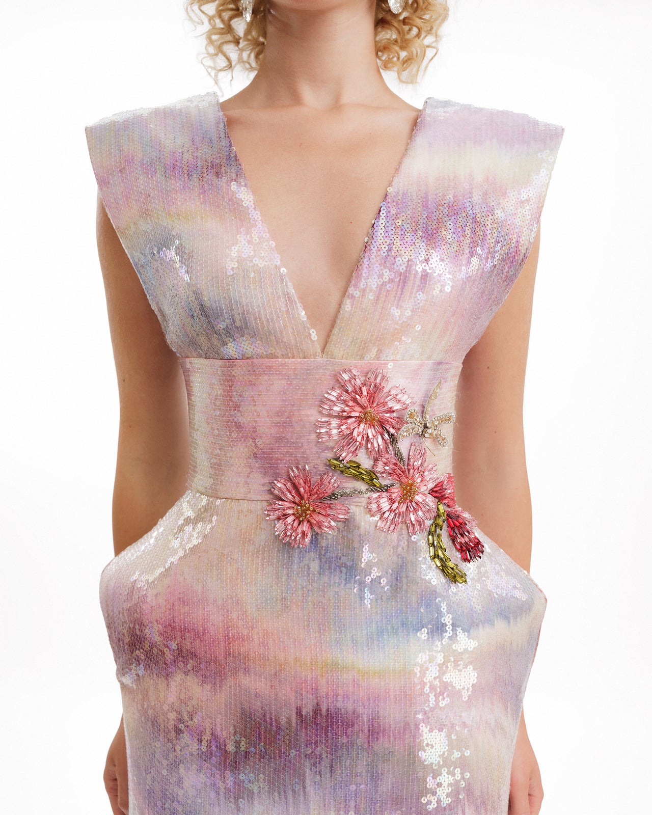 Sequined dress with floral embellishments on a white background