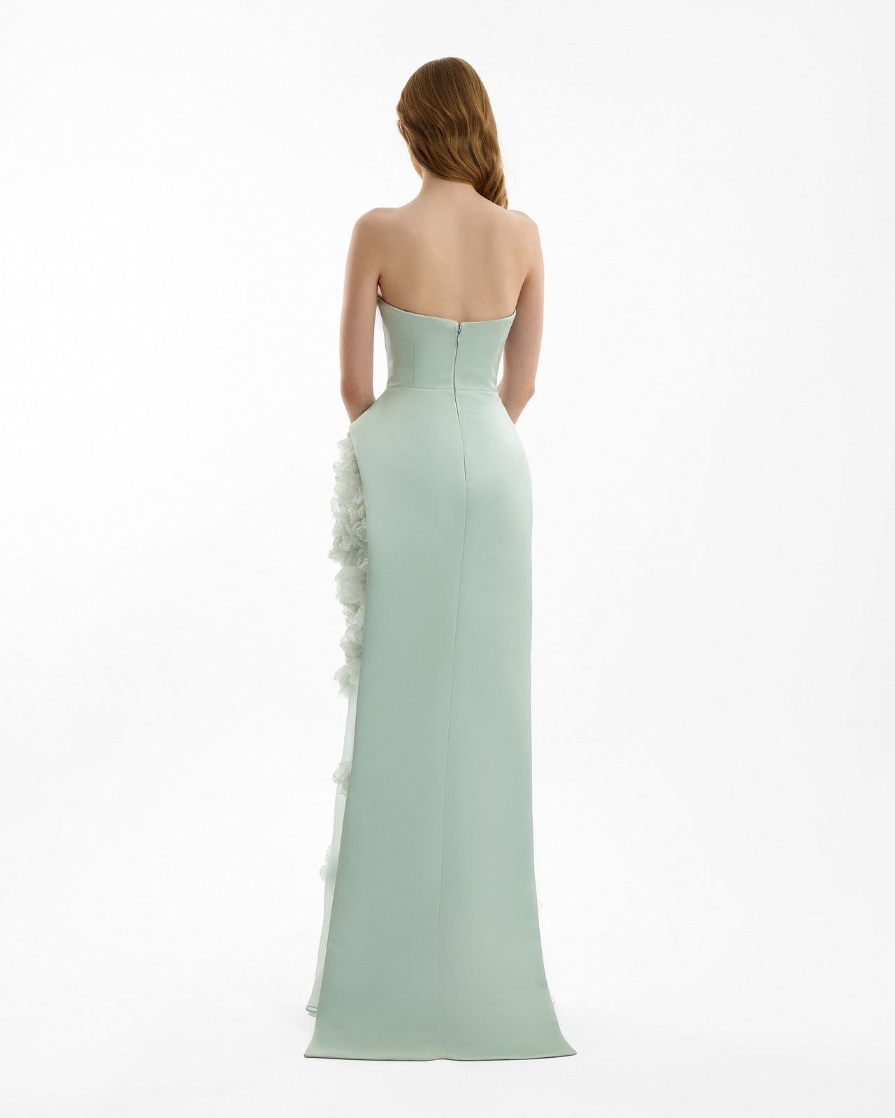 Mint green strapless gown with floral details on a white background