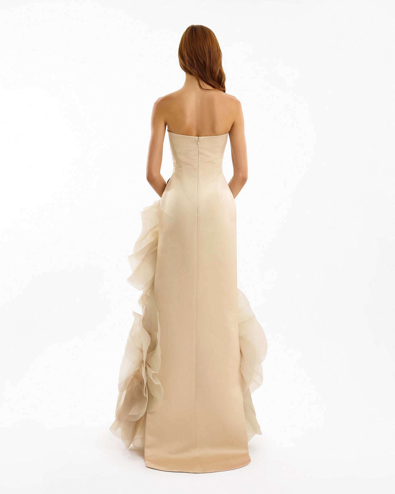 Beige strapless gown with ruffled skirt on a white background