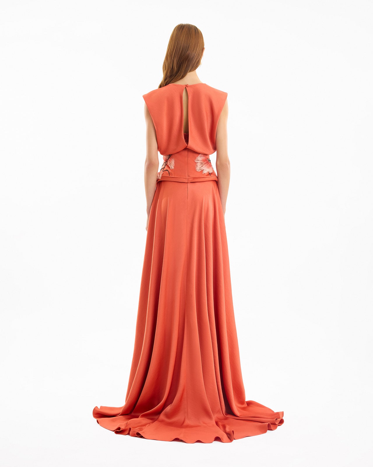 Coral evening gown with a open back design on a white background