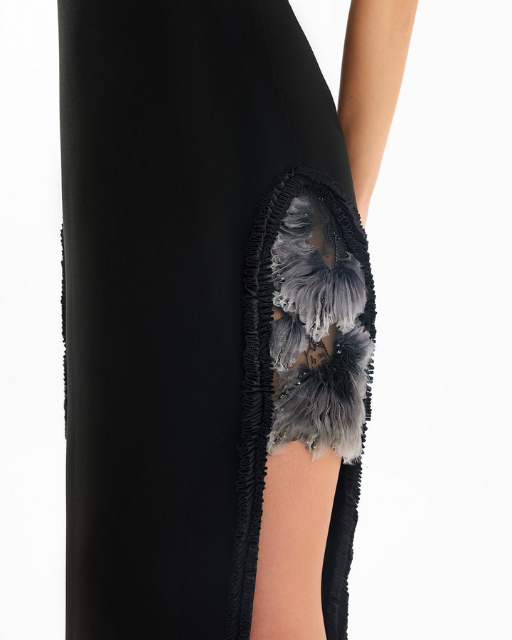 Black sleeveless top with floral embroidery on a white background