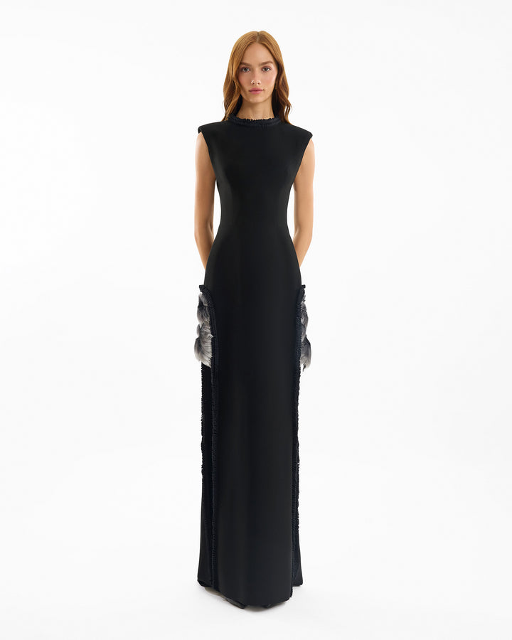 Black evening gown with silver embellishments on a white background