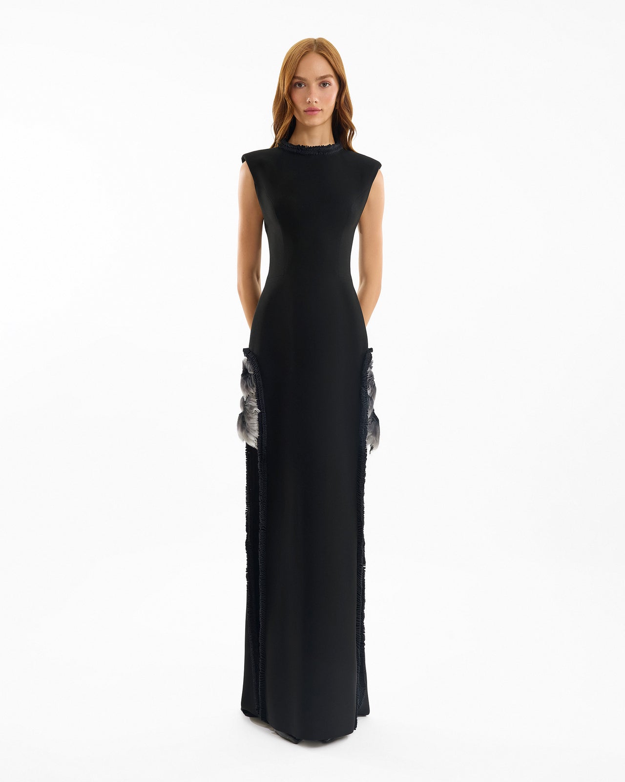 Black evening gown with silver embellishments on a white background