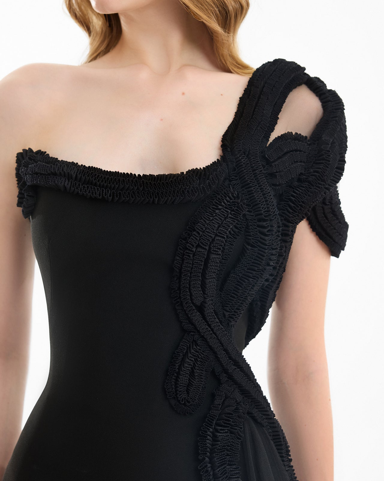 Black off-shoulder dress with textured shoulder detail on a white background