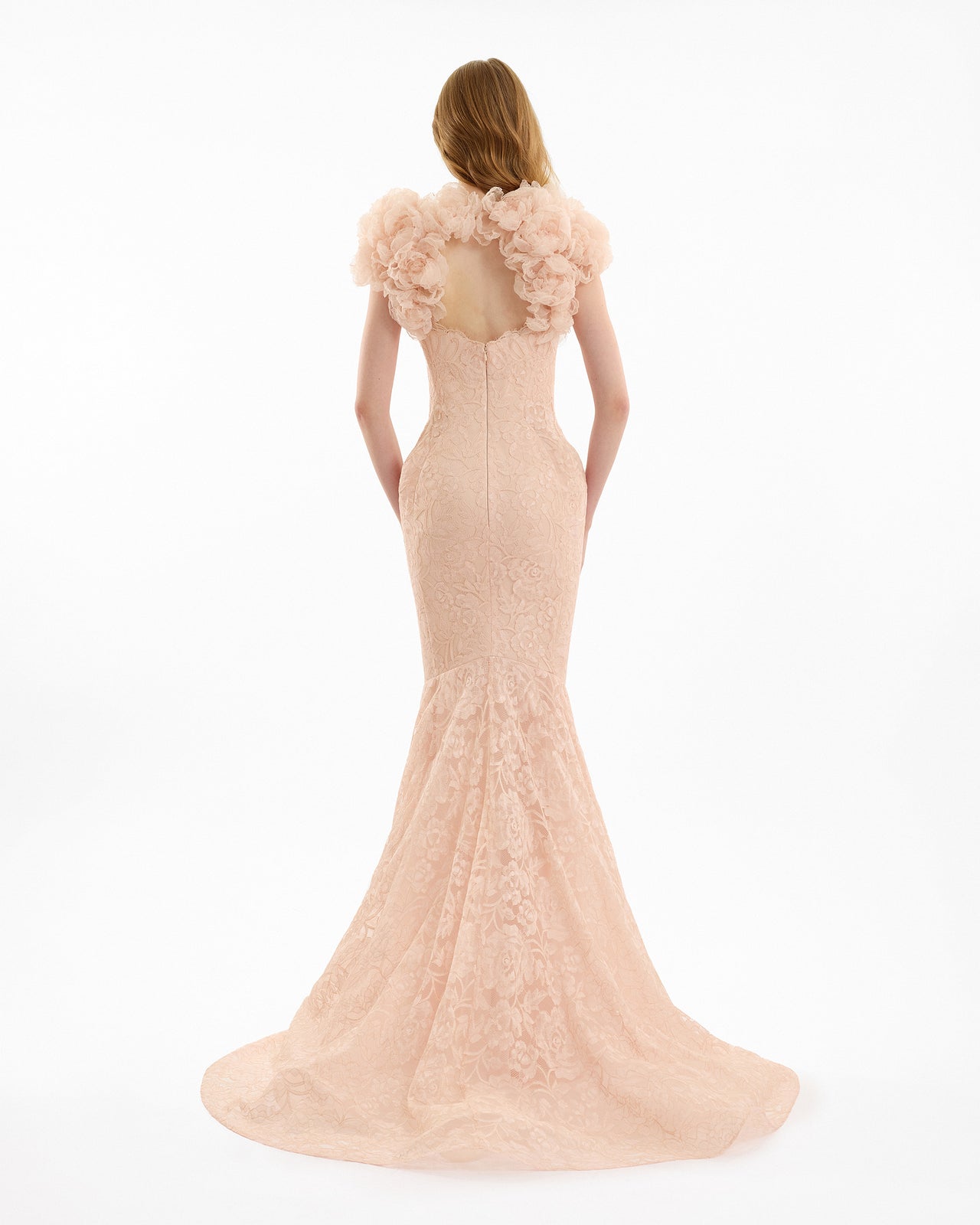 Blush pink evening gown with floral details on a white background