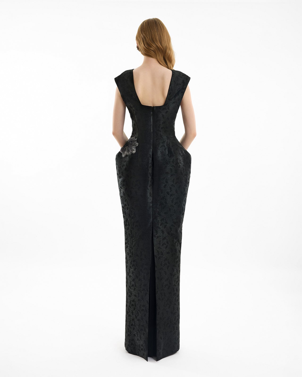 Black evening gown with floral details on a white background