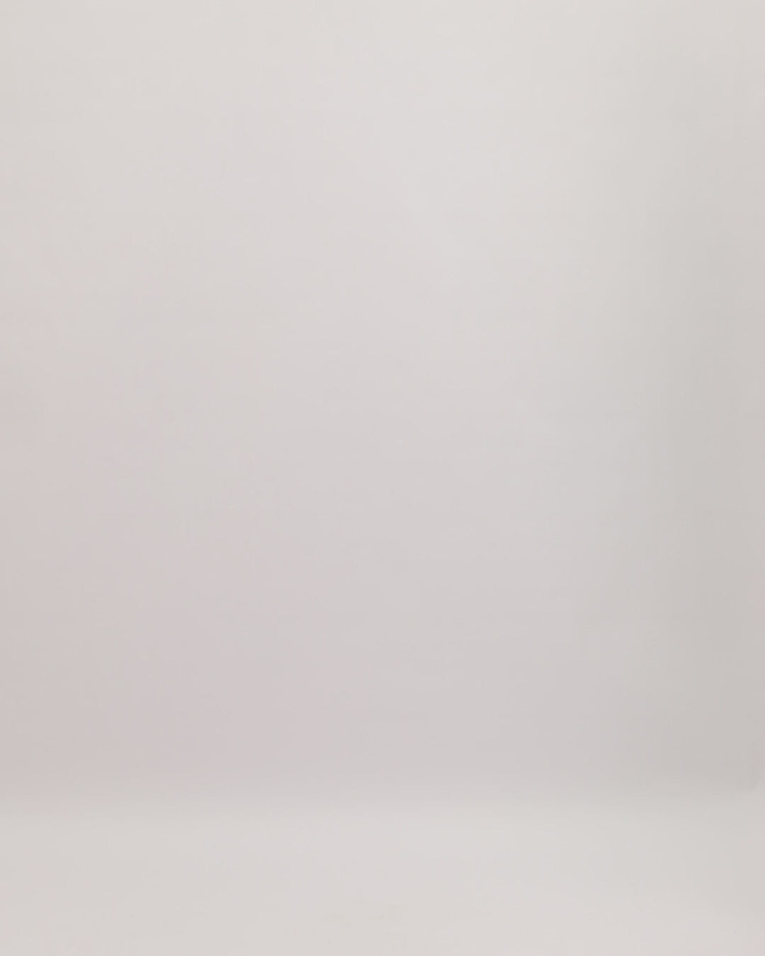  A short beaded evening dress in navy hues with cape-like sleeves and a see-through back.