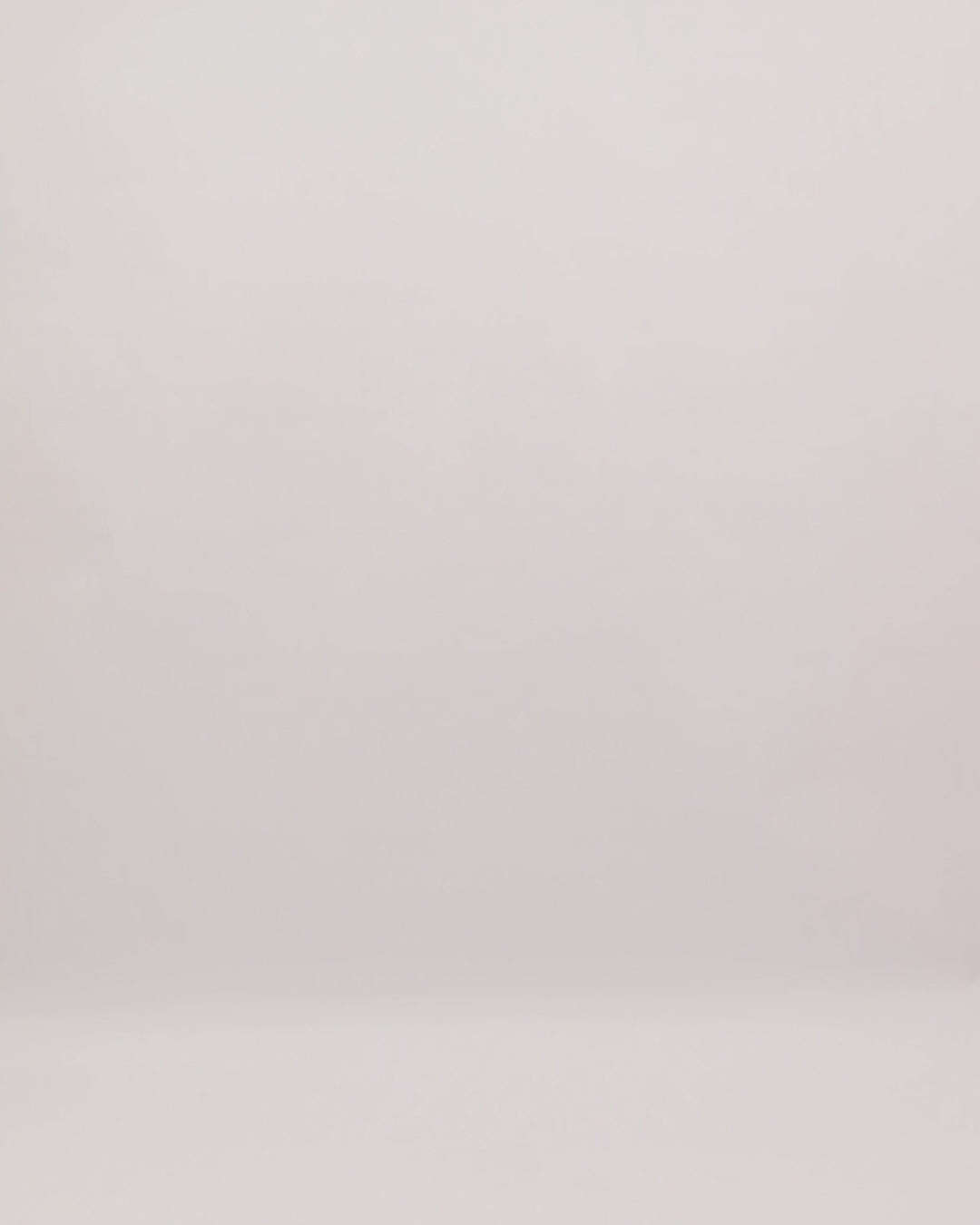 A v-neckline draped evening dress with a beaded belt and a back cut-out.