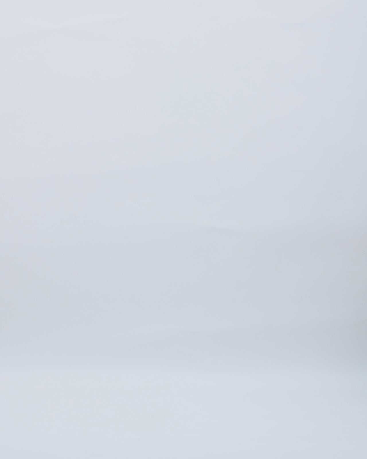 A long black evening dress in tulle with a bow-like stone embellished top.