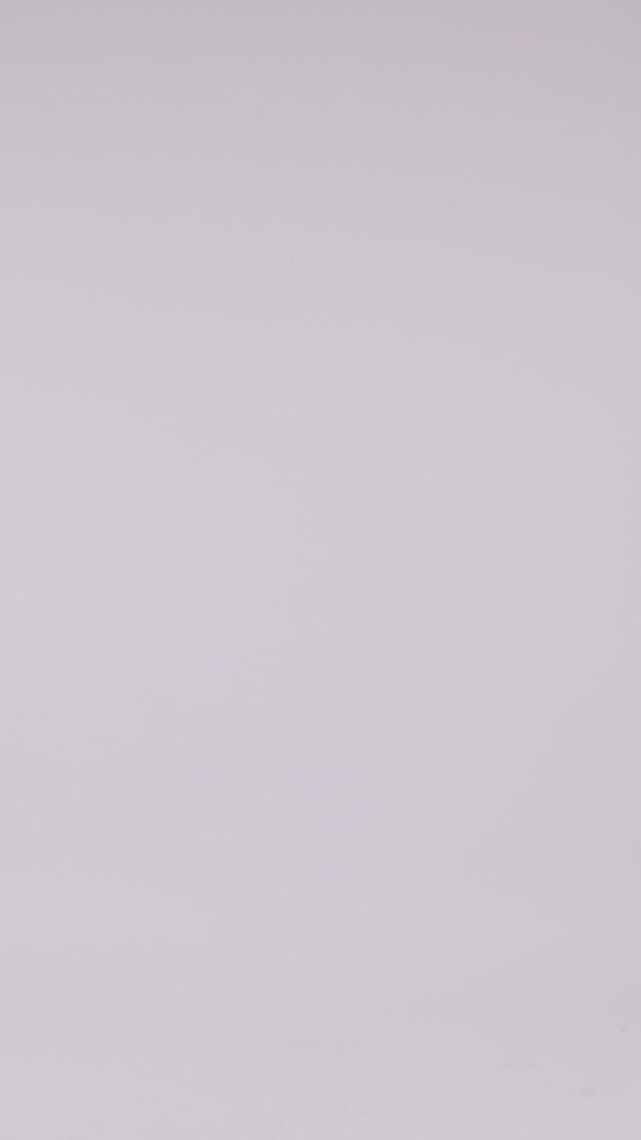 A slim-cut crepe lilac evening dress with an off shoulders bow-like neckline with thin straps, a belt on the waist, and ruffles on the back.