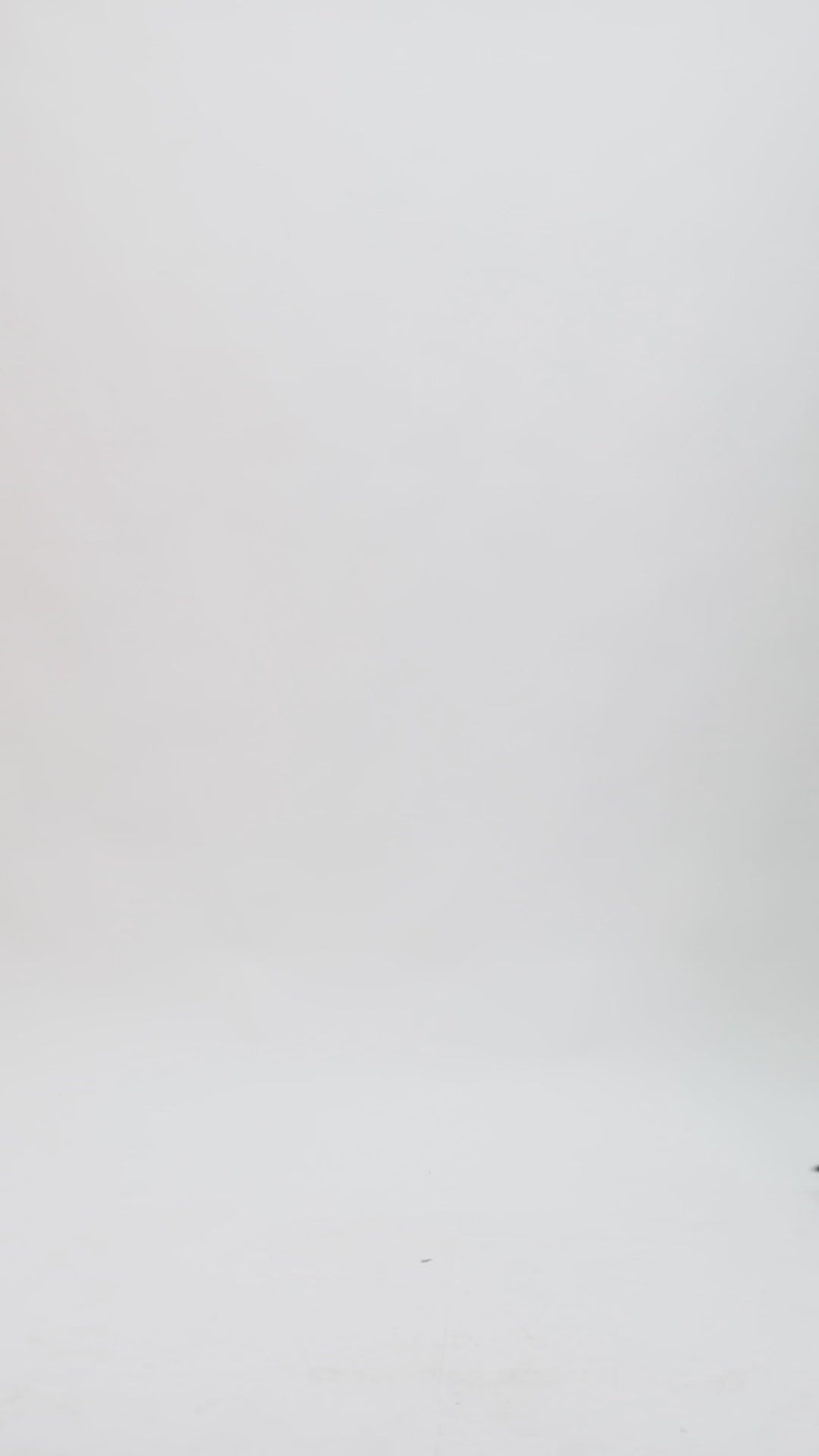 A black evening wear set featuring a squared-neckline crop top with floral cuffs paired with a long slim-cut skirt.