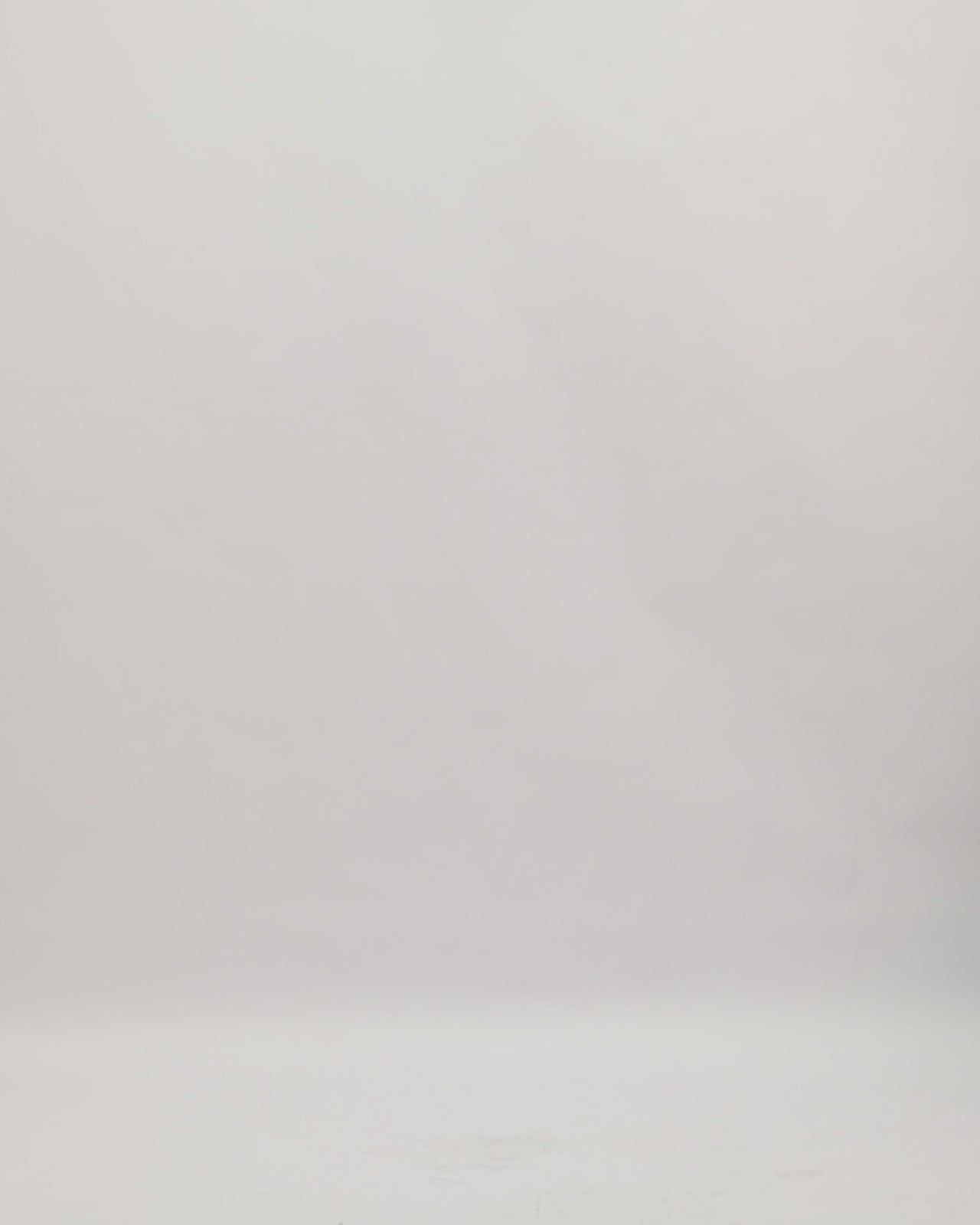 A one-shoulder beaded black evening dress with an asymmetrical tulle skirt.