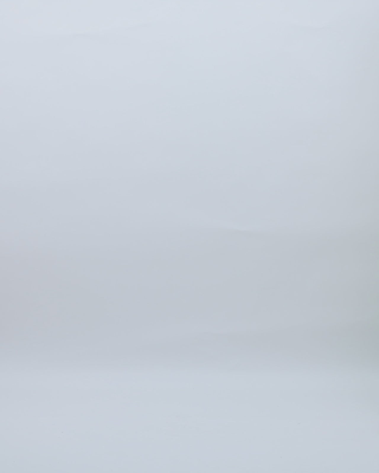 A v-neckline evening dress in pale lime color with draping on the waistline, cut-outs on the shoulders, and buttons on the sleeves.