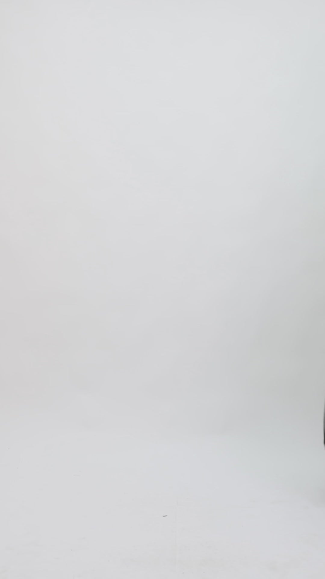 A black midi dress with off-the-shoulders draped florals featuring a see-through corset and flared tulle skirt with floral draping.