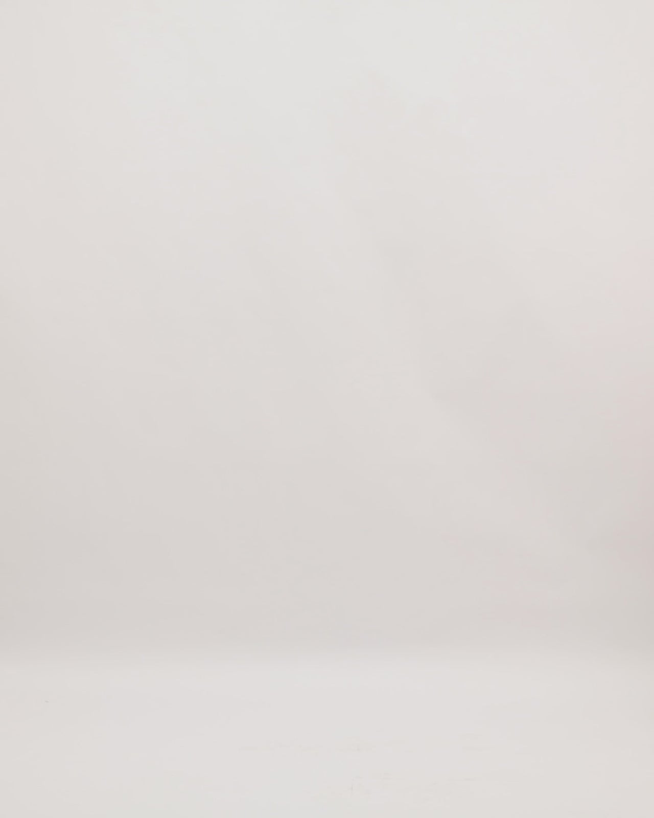 A v-neckline evening dress in embroidered laser-cut fabric featuring structured short sleeves.