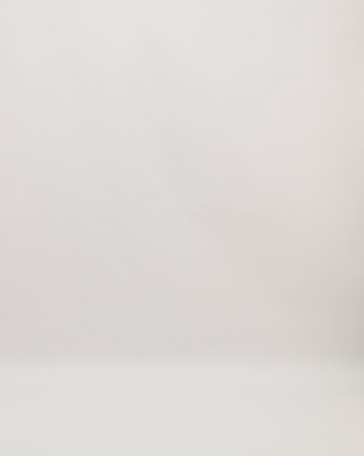 A beaded v-neckline evening dress in golden mustard color with short sleeves and a long cape.