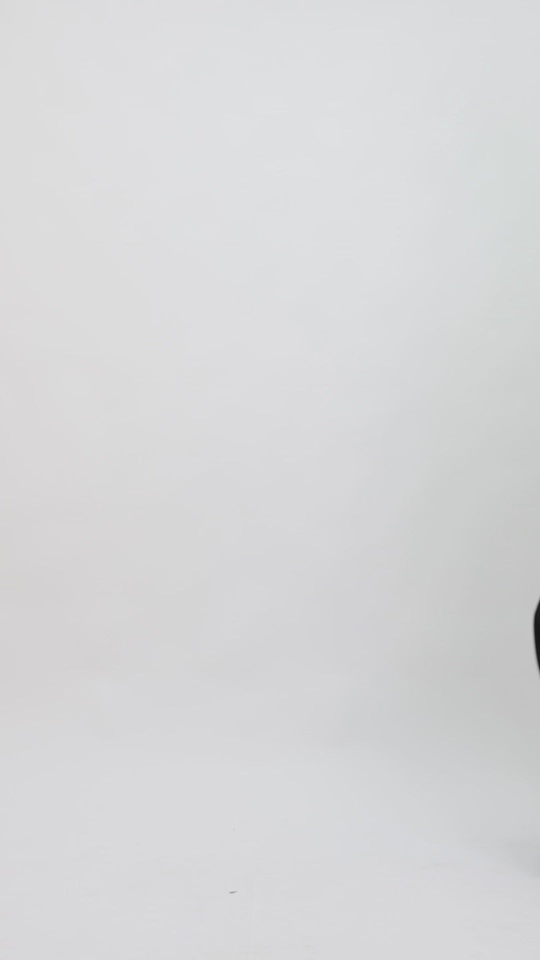 A black evening wear featuring a tube top with a beaded tulle overlay paired with a long slim-cut skirt.