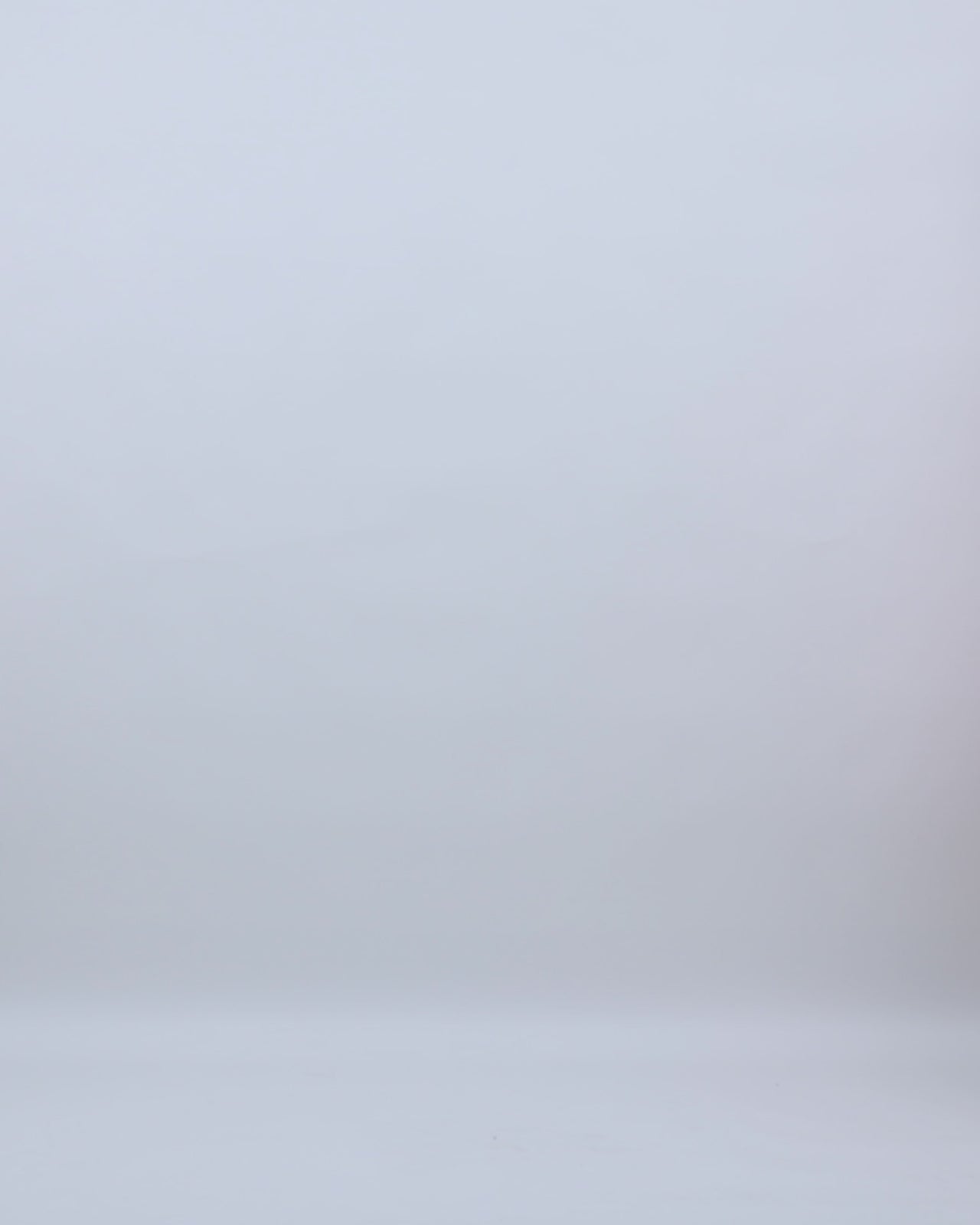 A slim-cut coral evening dress with beading details on the straps and cape-like sleeves.